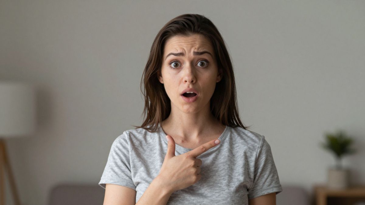 female pointing finger at herself